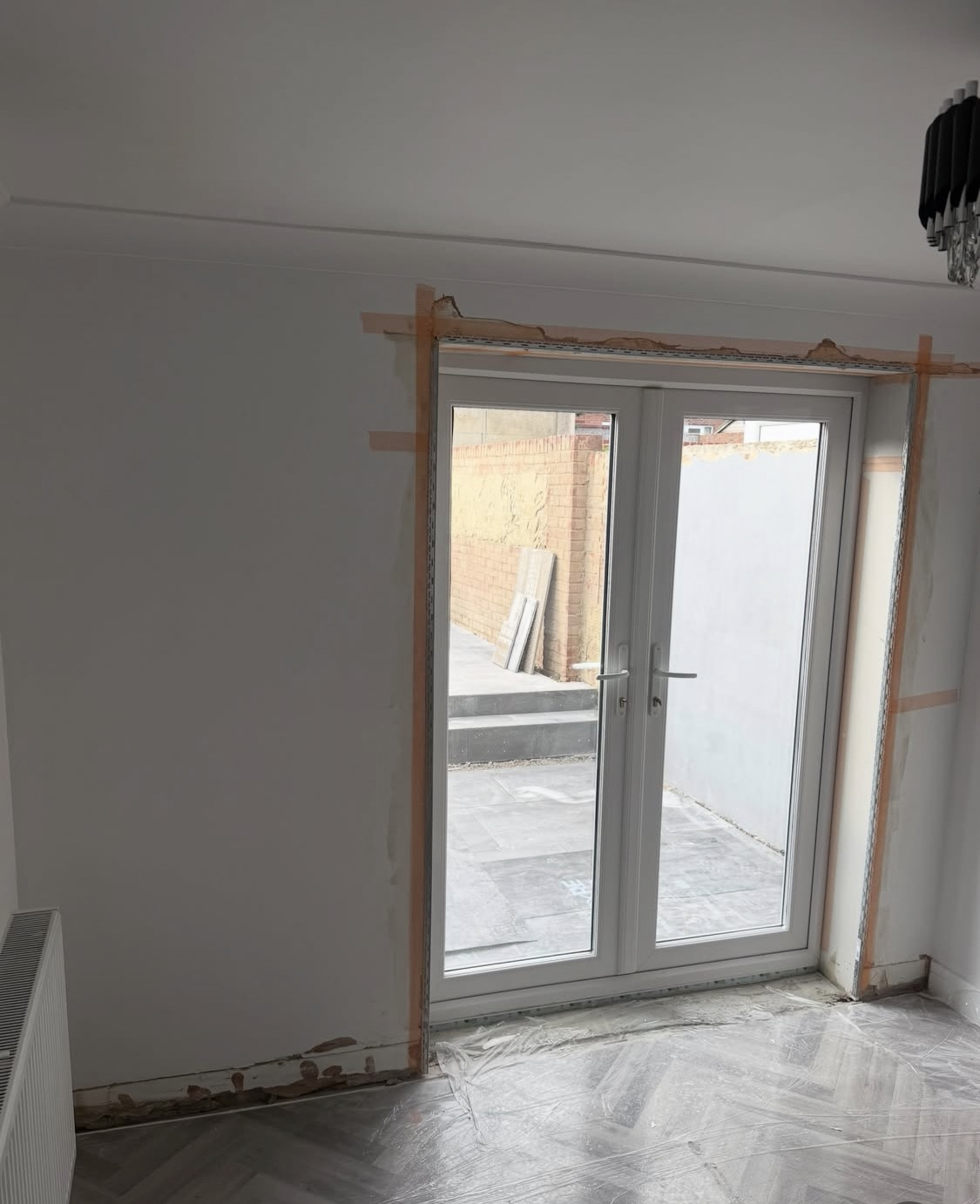 Interior room with fresh plasterboard and new patio doors