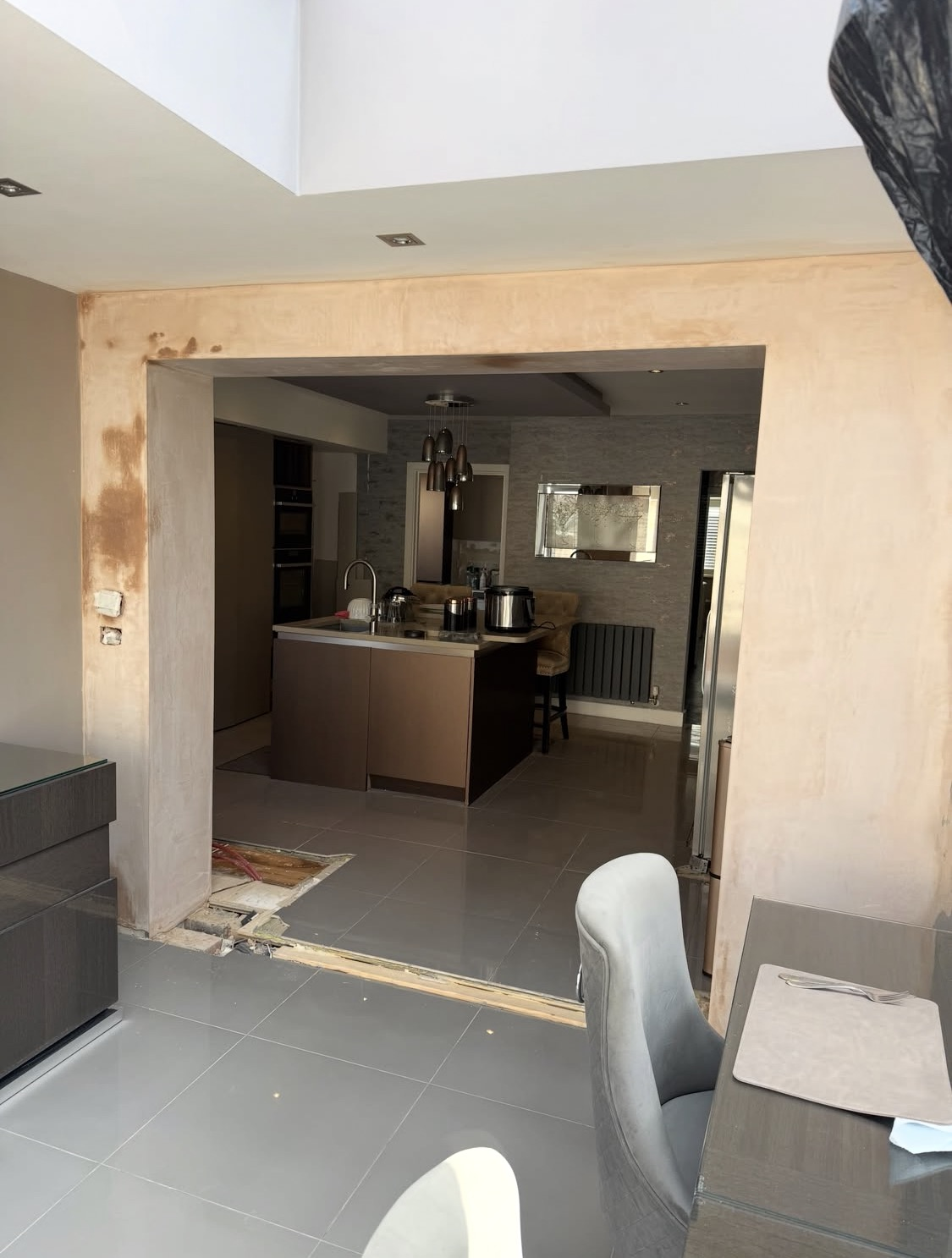 After: smooth plastered opening into the finished kitchen