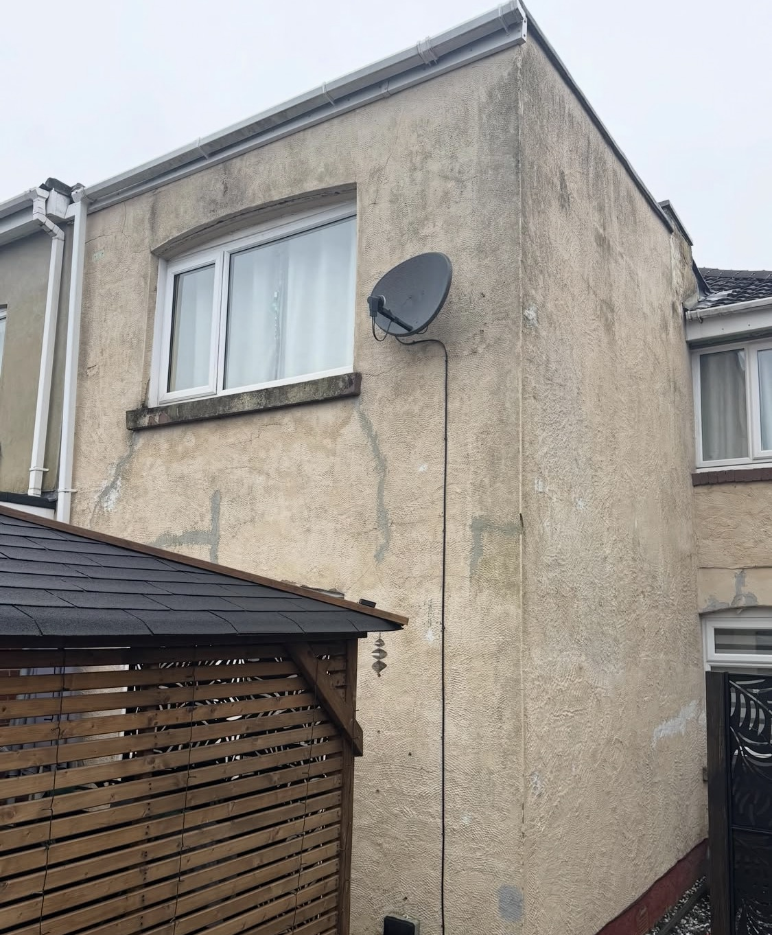Before: tired, weathered exterior render ready for a fresh finish