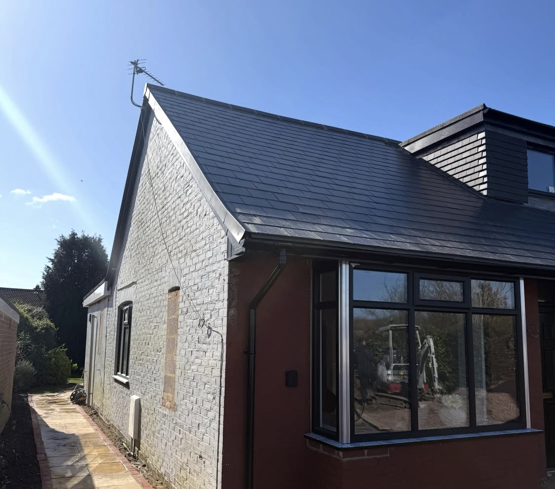 After: fresh coloured render and a new slate roof