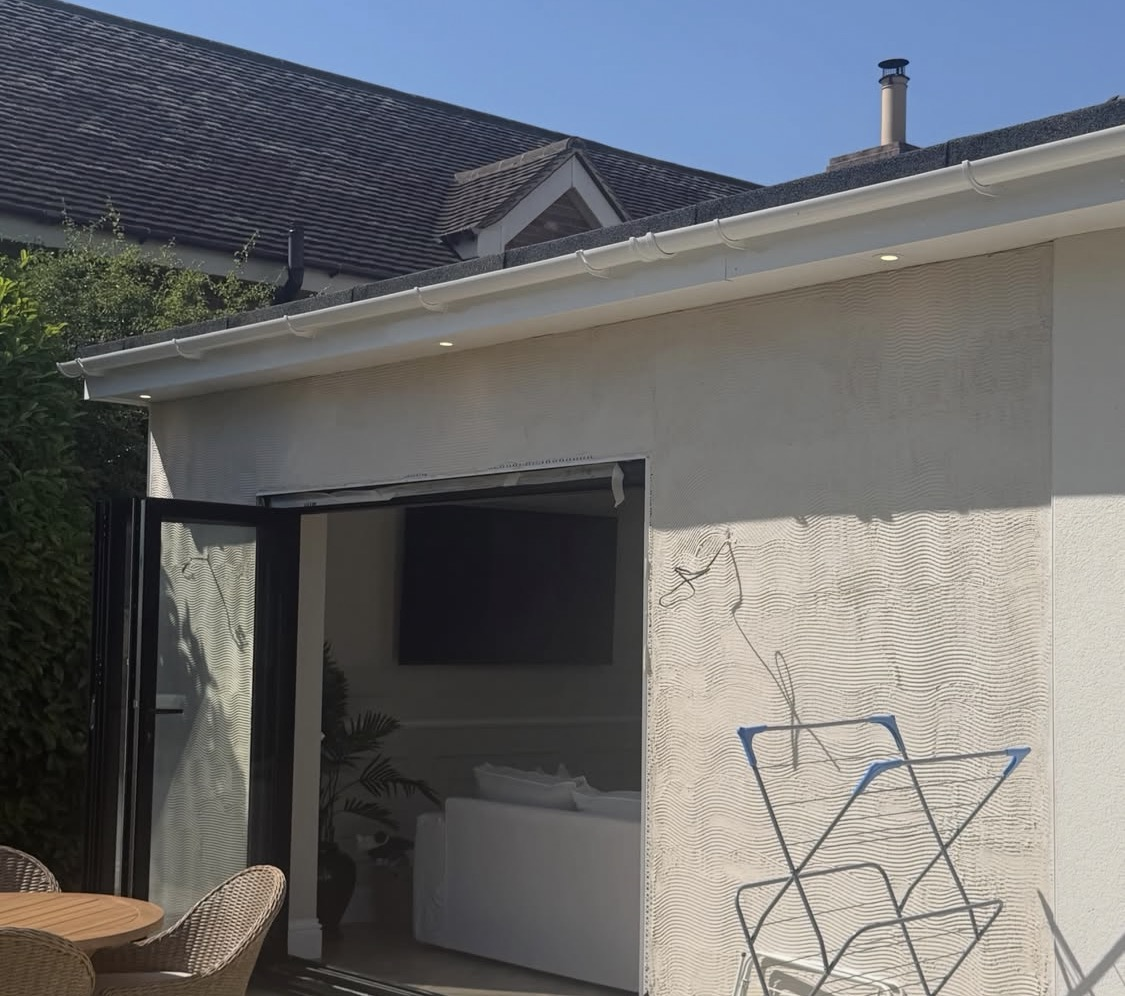 Base coat render being applied to a garden extension