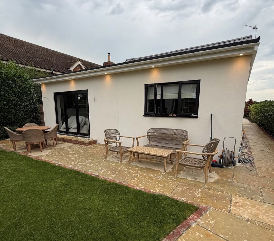 After: finished rendered bungalow with a new patio and garden