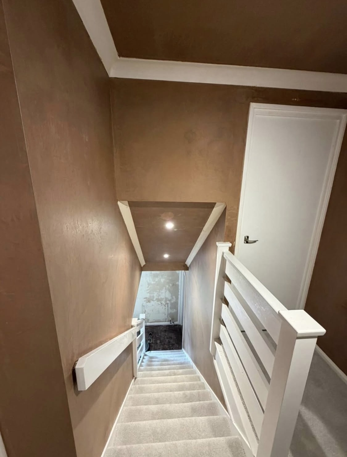 After: landing and stairwell finished in a smooth mocha plaster