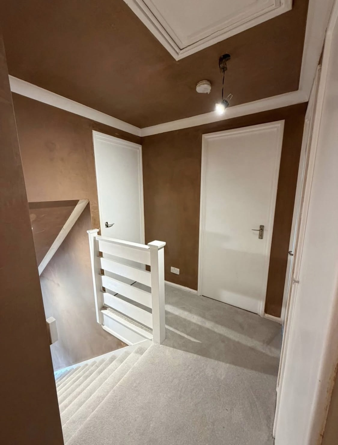 After: smooth plastered landing set off by crisp white joinery