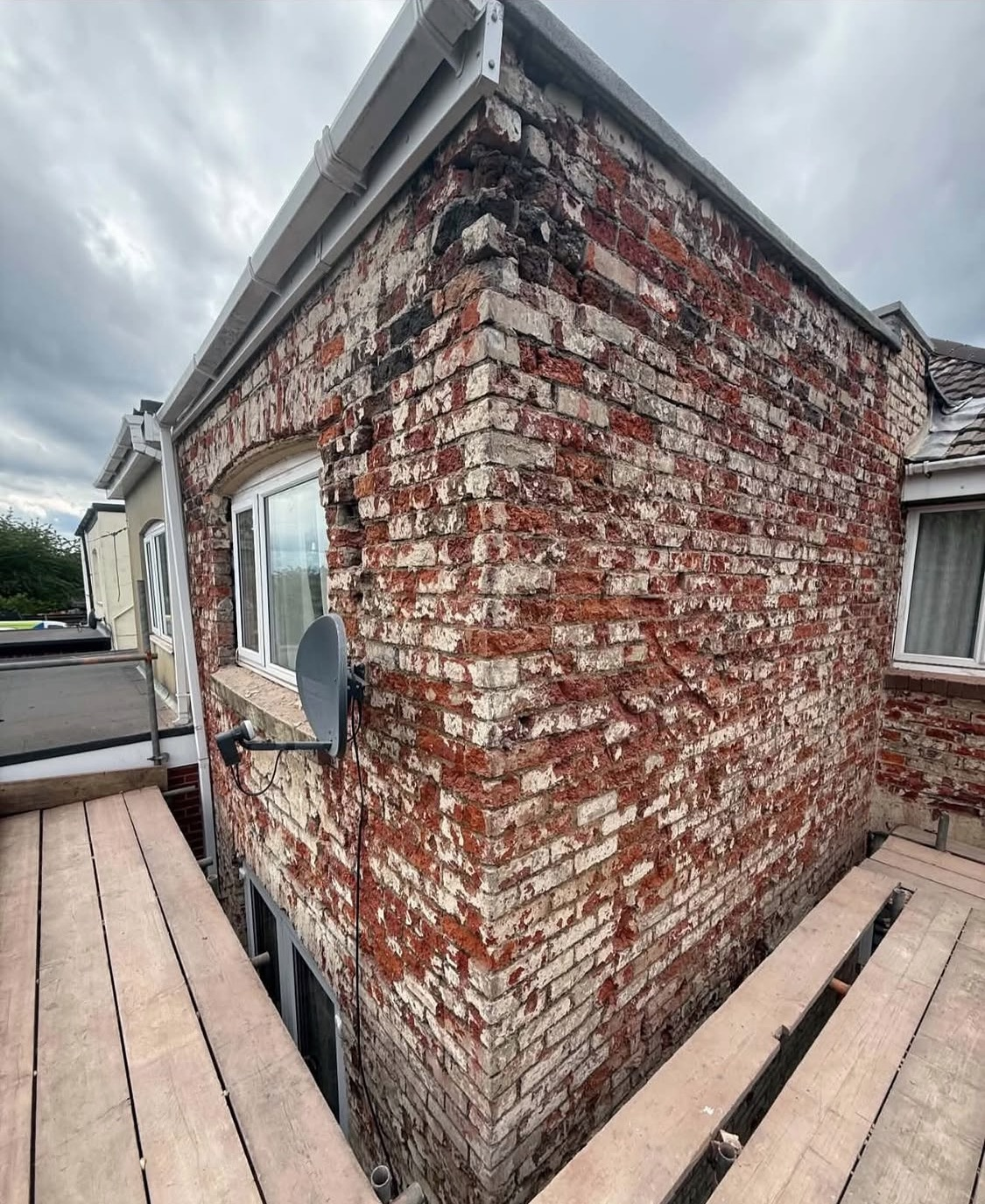 Before: tired, weathered brickwork ready for rendering